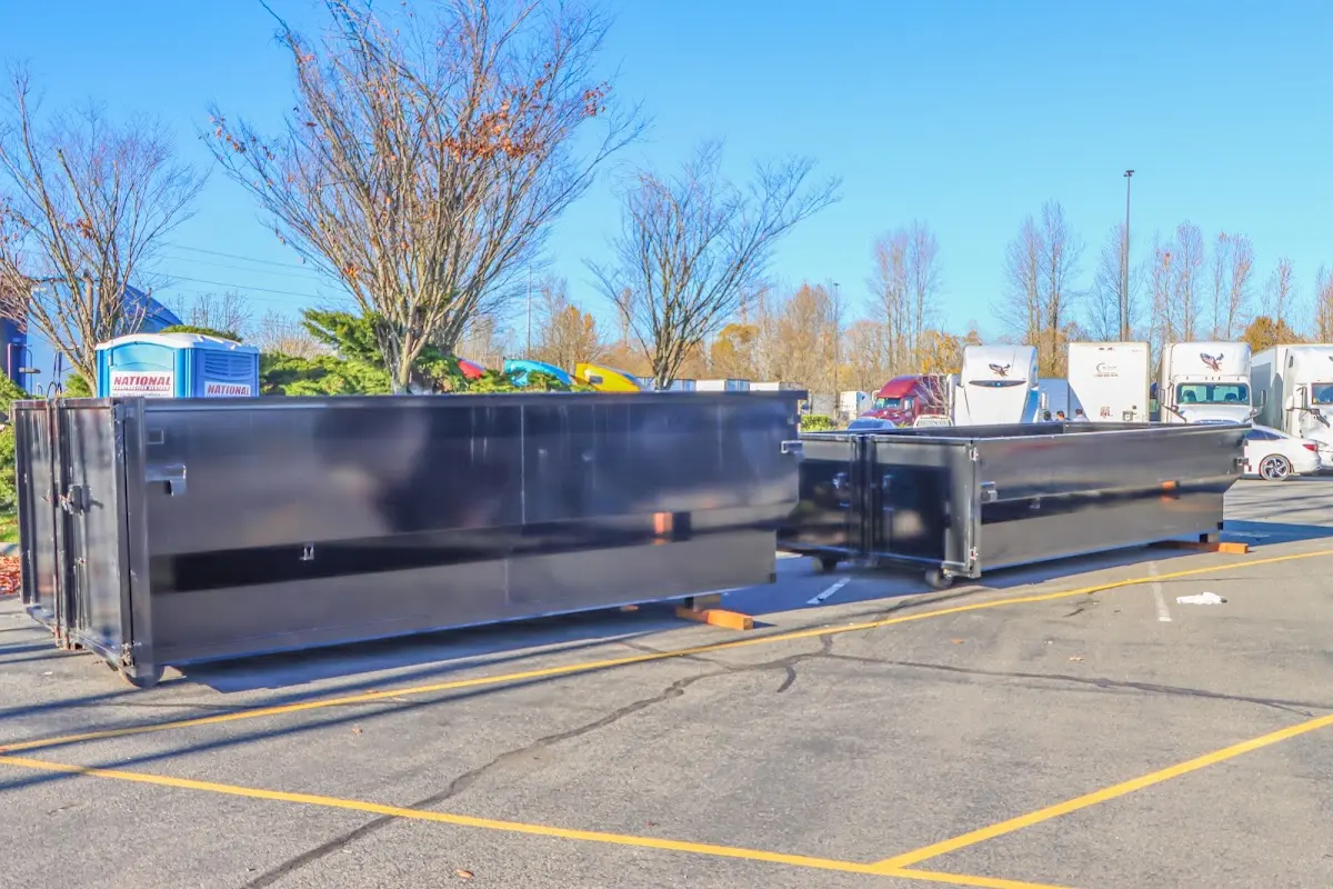 Professional dumpster rental service with roll-off container on residential driveway in Chamblee